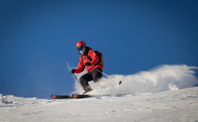 Skier carving down a snow-covered slope